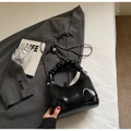 Chic black ruched shoulder bag with silver chain strap on grey blazer aesthetic - Black