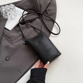 Chic black litchi grain leather mini crossbody phone bag on a grey suit jacket - Black without Pendant