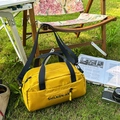 Chic lemon yellow nylon crossbody bag with black handles on a camping lawn scene - Yellow