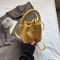 Chic yellow bucket bag with woven handle and drawstring in pebbled faux leather - Yellow