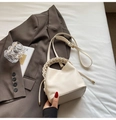 Chic beige bucket bag in lychee leather with a woven handle for casual commuting - Off White