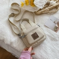 Beige nylon crossbody bag with leather logo patch and adjustable strap on quilted background - Off-white / Small