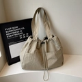 Large beige nylon drawstring tote bag with pleated texture and adjustable strap for travel - Khaki