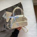Chic cream bow shoulder bag with glossy pleated leather and lace trim for women - Off-white