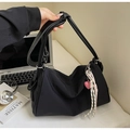 Detail of black nylon pillow bag with pink heart charm and braided rope accessory - Black