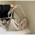 Detail of cream canvas pillow bag showing the heart pendant and soft pleated texture - Off White