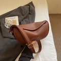 Detail of dark brown lychee textured leather bag with polished gold metal buckle - Brown