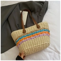 Detailed close-up of woven paper straw tote with vibrant colorful stripes and leather straps - Orange and Beige