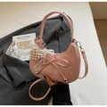Pink crescent bag detail with a delicate bow, white lace, and pearl decorations - Pink