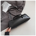 Detail of minimalist black baguette bag on grey blazer with adjustable shoulder strap - Black
