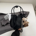 Minimalist black lychee pattern bucket bag with a cute plush bear charm for women - Black with Pendant