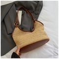 Straw woven crescent shoulder bag with brown leather handles and wavy texture details - Brown