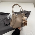 Chic beige lychee leather bucket bag with cute teddy bear charm and adjustable strap - Khaki with Pendant