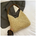 Close-up of woven straw tote bag with brown leather strap and mesh texture detail - Pattern 5