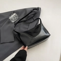 Minimalist black patent leather underarm bag with adjustable strap on grey suit - Black without Pendant