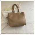 Minimalist large khaki leather tote bag with dual handles on white fabric background - Brown