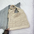 Chic cream white handmade crochet tote bag with geometric hollow patterns on denim jacket - Off White