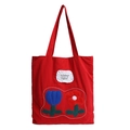 Red fabric tote bag featuring blue tulip appliques and inspirational English quote - Red