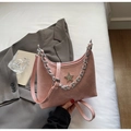 Detail of pink pleated leather bag featuring a silver chain and sparkling star emblem - Pink