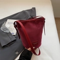 Chic burgundy frosted suede bucket bag with adjustable strap and leather nameplate - Burgundy