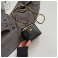 Detail of black ostrich texture bag with gold flower logo and metal chain strap - Black Small