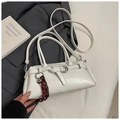 Close-up of white leather underarm bag with belt buckle detail and woven key charm - White With Pendant