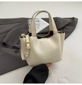 Minimalist beige leather bucket bag with top handle and gold-tone hardware detail - White
