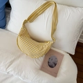 Yellow and white checkered dumpling bag with a striped crossbody strap on a white pillow - Yellow