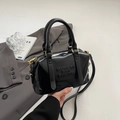 Sac Boston noir brillant avec lettres embossées et détails dorés sur un costume - Noir sans Pendentif