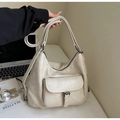 Primer plano del bolso tote blanco crema con hebilla de cuero y textura de piel sintética - Beige