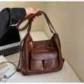 Detailed close-up of brown oiled leather texture and buckle hardware on a tote bag - Dark Brown