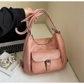 Detail of a dusty pink leather tote bag with buckle pocket and adjustable straps - Pink