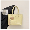 Detail of light yellow crocodile pattern tote bag with bear charm and silver hardware - Yellow