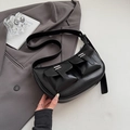 Polished black faux leather crescent tote bag with utility pockets and silver buckles - Black