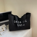 Minimalist black canvas tote bag with white DAKI & BAG artistic lettering and embroidery - Black