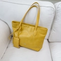 Fashionable mustard yellow large tote bag with matching mini coin purse on white sofa - Yellow