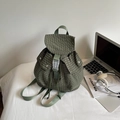 Detail of green plaid backpack featuring drawstring closure and durable buckle strap - Green