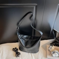 Minimalist black leather bucket bag with zipper and adjustable dual shoulder straps - Black