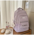 Close-up of lilac purple nylon school backpack with multiple pockets and plush star charm - Purple