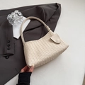 Minimalist hand-woven shoulder bag in cream beige leather texture on grey suit background - Off White
