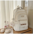 Close-up of beige nylon backpack with multi-layer zippers and star plush charm - White