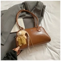 Brown leather underarm shoulder bag with cute teddy bear charm and polished finish - Brown with Pendant