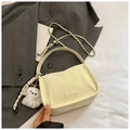 Detail of a beige textured mini bag with leather chain strap and cute plush dog charm - With Pendant / Yellow