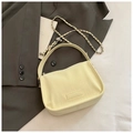 Minimalist cream beige leather shoulder bag featuring a silver skull chain and brand logo - Yellow Without Pendant