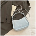 Fashionable light blue leather underarm bag with silver chain strap on vintage background - Blue Without Charm