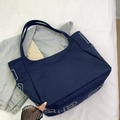 Navy blue canvas tote bag with large white letter print in casual modern style - Blue