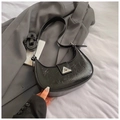 Detail of black crescent bag featuring wrinkled oil-wax texture and metal buckle - Black