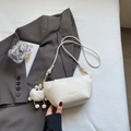 Chic white leather cloud crossbody bag with golden logo and plush charm accessory - Cream White with Pendant