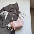 Minimalist light pink crossbody bag with gold hardware and plush charm on blazer - Pink With Pendant