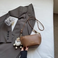 Brown leather pleated cloud crossbody bag with fluffy white charm and gold hardware - Brown with Pendant